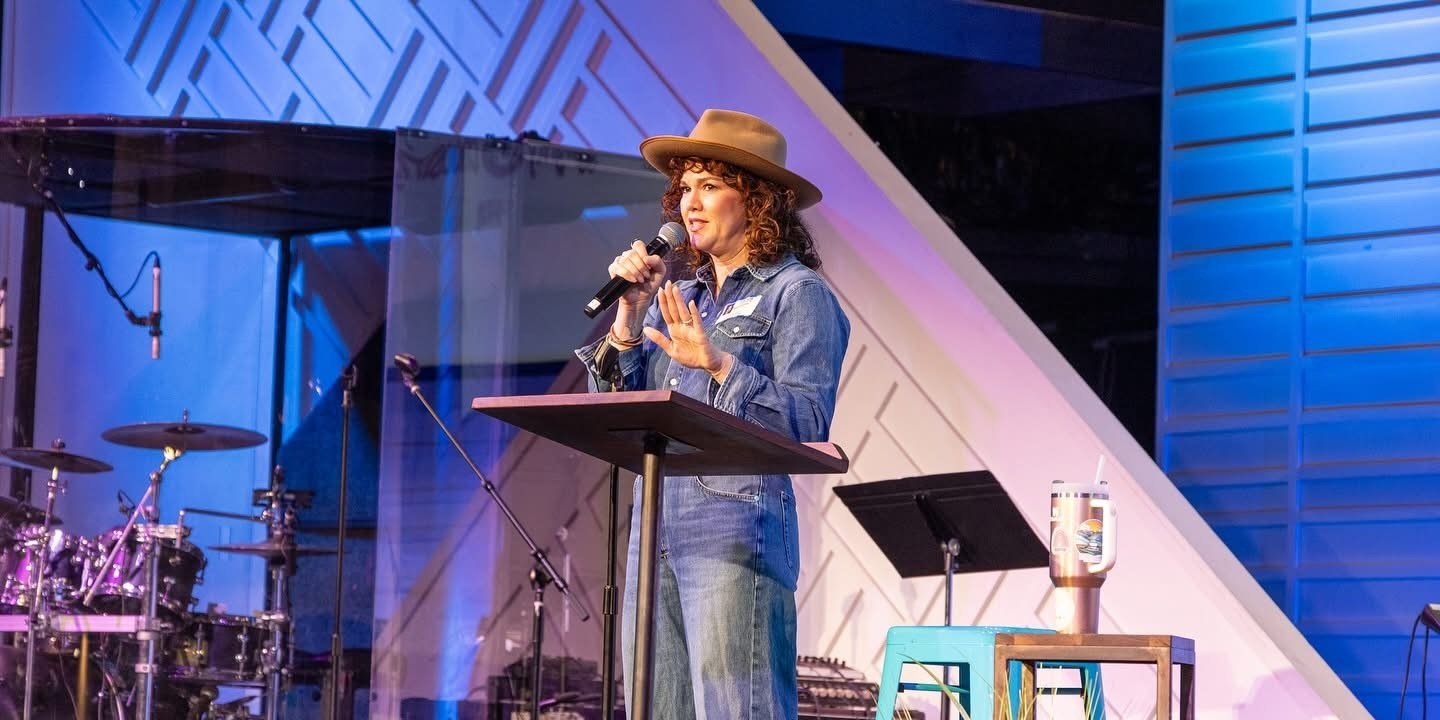 Kasey Brennan speaking on stage